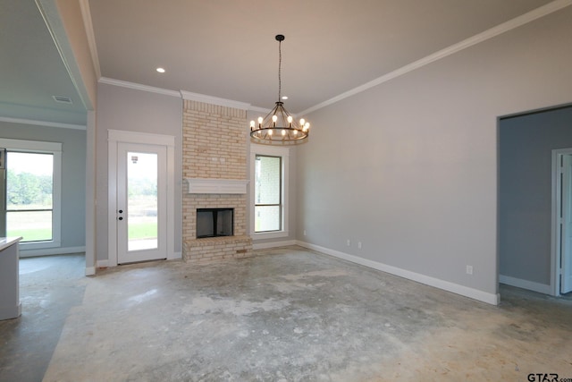 unfurnished living room with a brick fireplace, plenty of natural light, a chandelier, and crown molding