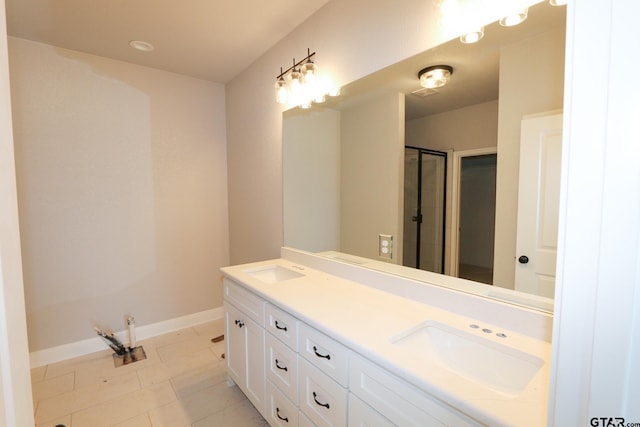 bathroom with vanity, tile patterned floors, and a shower with door