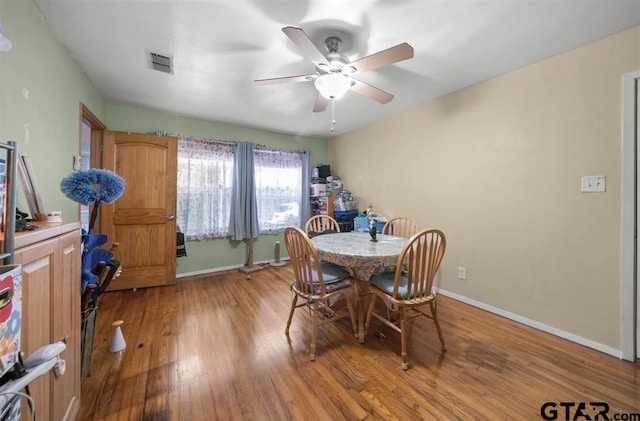 dining space with ceiling fan, visible vents, baseboards, and light wood-style floors