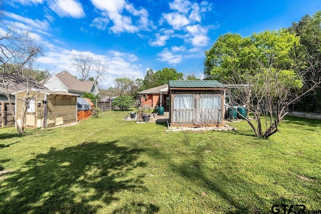 view of yard with an outdoor structure, fence private yard, and a shed