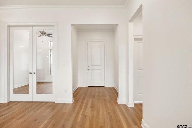 hallway with french doors, light hardwood / wood-style floors, and ornamental molding