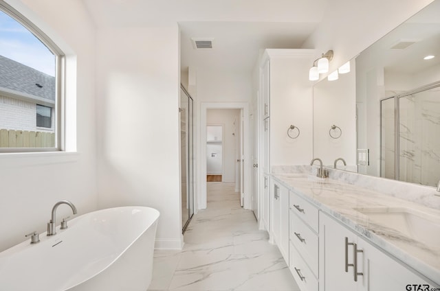 bathroom featuring vanity and shower with separate bathtub