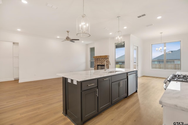 kitchen with pendant lighting, stainless steel appliances, ceiling fan, and sink