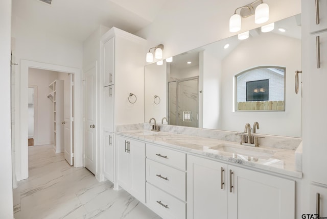 bathroom with lofted ceiling, vanity, and an enclosed shower