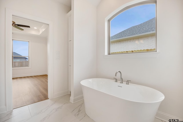 bathroom featuring a bath and ceiling fan