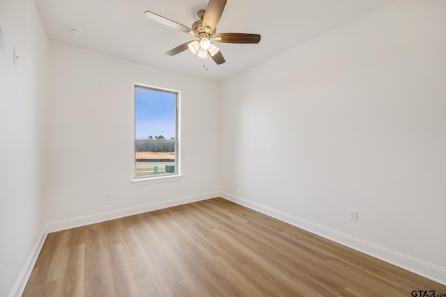 spare room with ceiling fan and light wood-type flooring