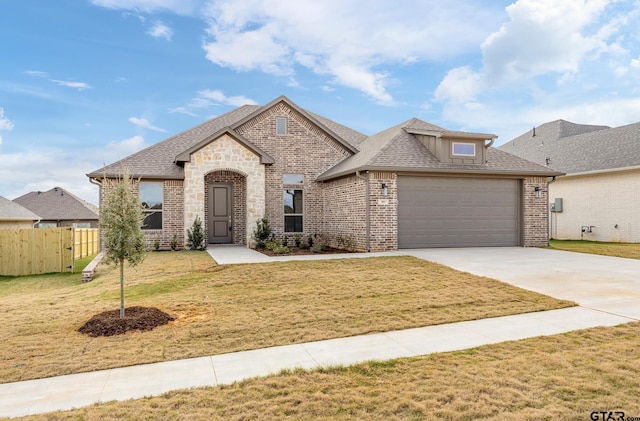 view of front of property with a front lawn and a garage