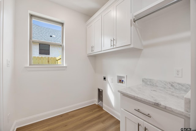 clothes washing area with hookup for an electric dryer, light hardwood / wood-style floors, cabinets, and hookup for a washing machine