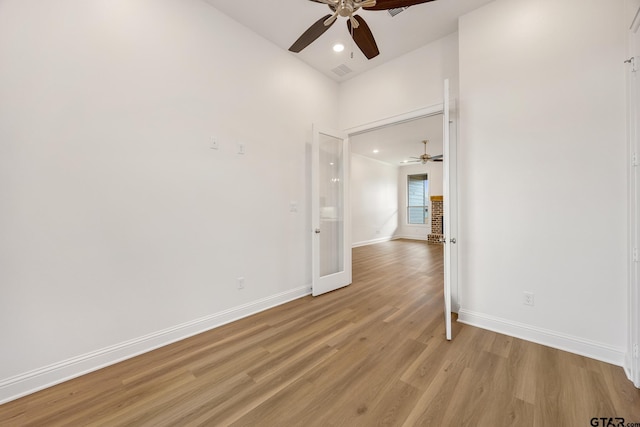 unfurnished room with ceiling fan and light hardwood / wood-style floors