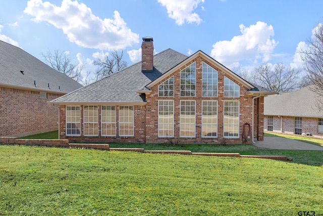 back of house featuring a yard