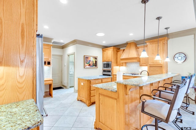 kitchen with light brown cabinets, backsplash, a kitchen island, appliances with stainless steel finishes, and custom exhaust hood