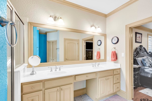 full bathroom with double vanity, ornamental molding, and a sink