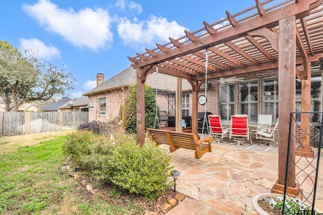 view of patio / terrace featuring a pergola and fence