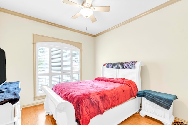 bedroom featuring multiple windows, a ceiling fan, crown molding, and light wood finished floors