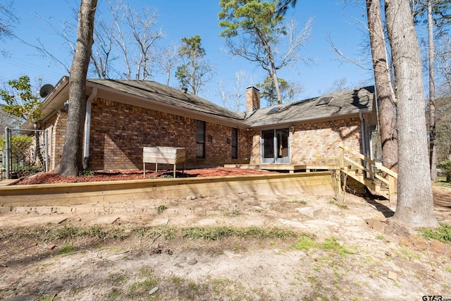 1511 Dolly Ln, Hideaway, TX 75771 - rear view of house featuring a chimney and brick siding