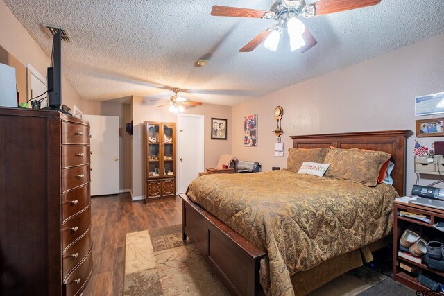 1511 Dolly Ln, Hideaway, TX 75771 - bedroom featuring a textured ceiling, dark wood finished floors, and a ceiling fan