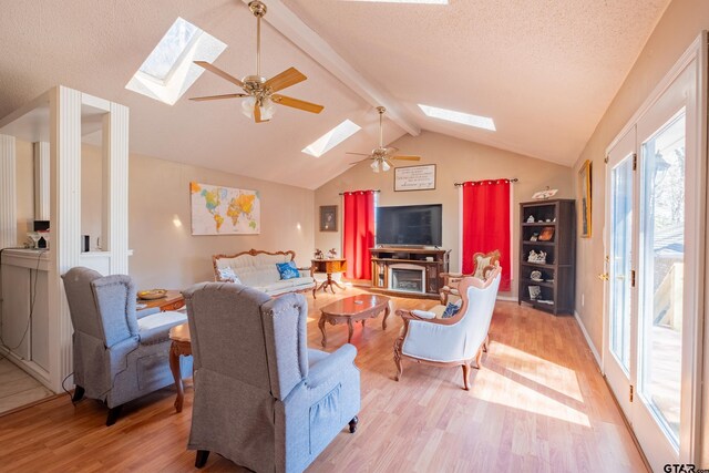 1511 Dolly Ln, Hideaway, TX 75771 - living area featuring a skylight, light wood finished floors, a ceiling fan, and a textured ceiling