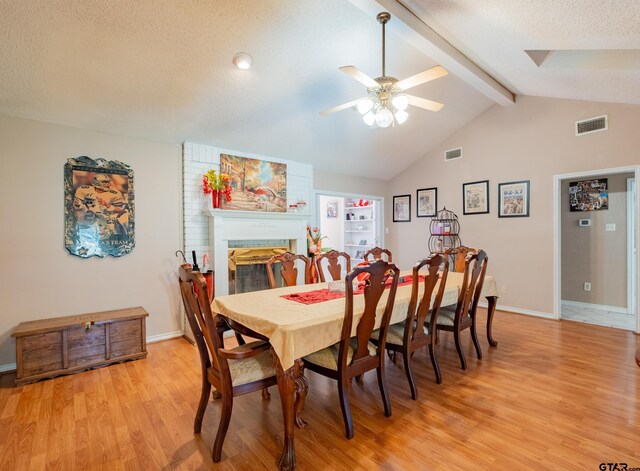 1511 Dolly Ln, Hideaway, TX 75771 - dining area with light wood-style flooring, ceiling fan, beamed ceiling, a textured ceiling, and high vaulted ceiling