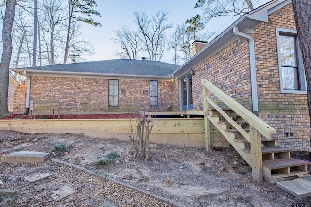 1511 Dolly Ln, Hideaway, TX 75771 - rear view of house featuring brick siding and a chimney