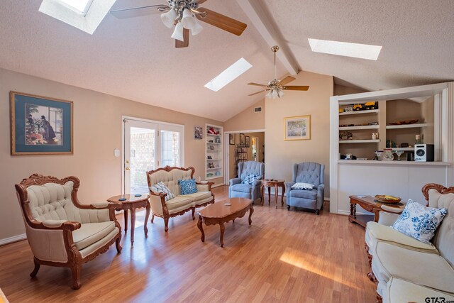1511 Dolly Ln, Hideaway, TX 75771 - living area featuring a skylight, a ceiling fan, light wood-style flooring, built in features, and a textured ceiling