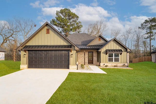 view of front of property featuring an attached garage, driveway, board and batten siding, a standing seam roof, and a front yard