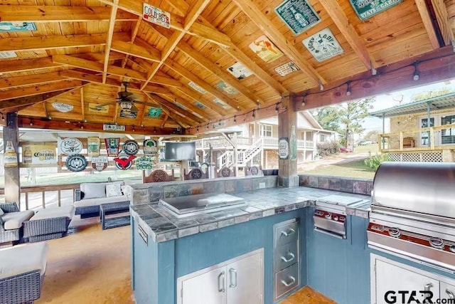 view of patio / terrace featuring exterior kitchen and a grill