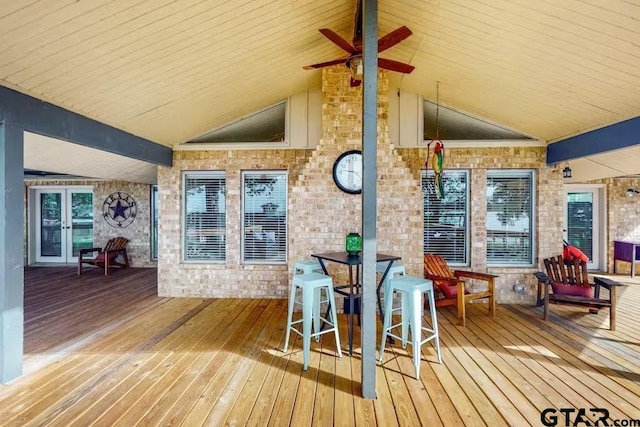 deck featuring french doors, outdoor dining space, and a ceiling fan