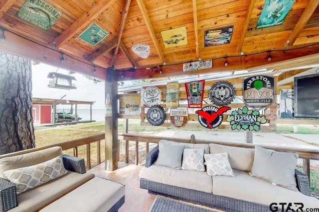 living room featuring lofted ceiling with beams, wood ceiling, and a wealth of natural light