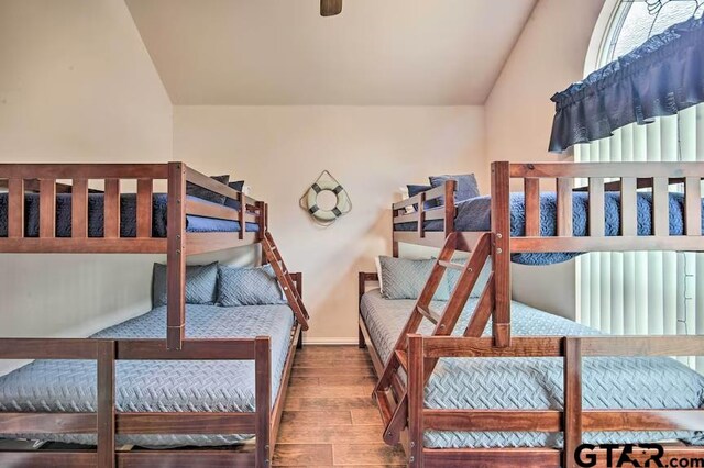 bedroom featuring lofted ceiling and hardwood / wood-style flooring