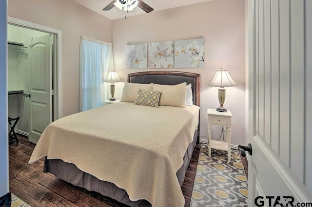 bedroom with dark hardwood / wood-style flooring and ceiling fan