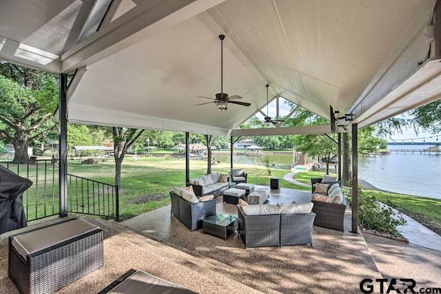 view of patio / terrace featuring a water view, ceiling fan, and an outdoor living space