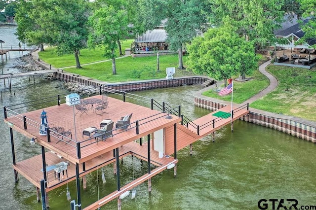 dock area featuring a water view and a lawn