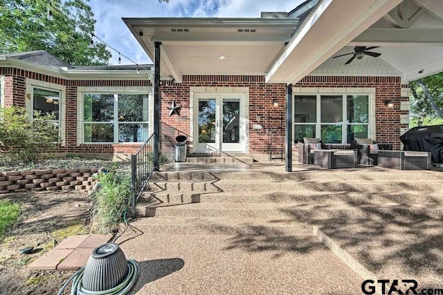 rear view of property featuring ceiling fan and a patio area