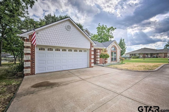 view of front of property featuring a garage and a front lawn