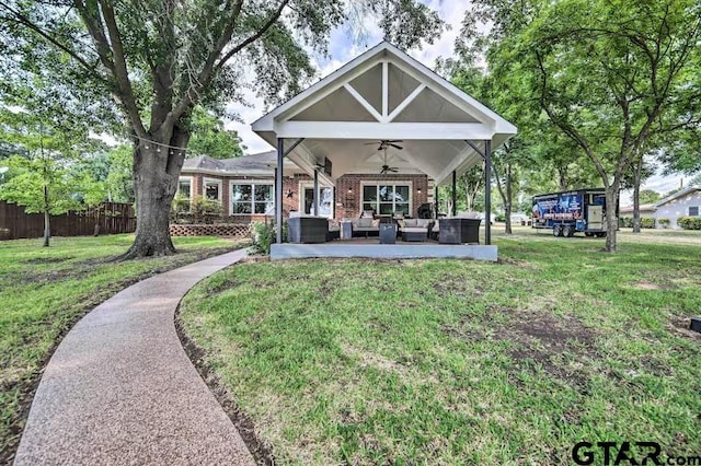 view of front of home featuring ceiling fan, a front yard, and an outdoor hangout area