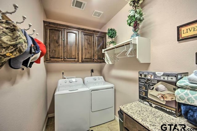 washroom featuring cabinets and independent washer and dryer