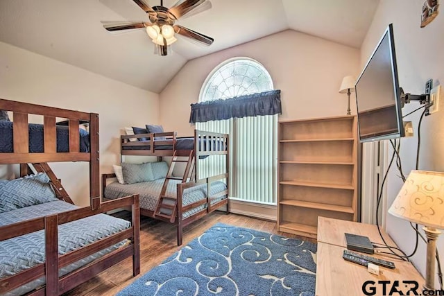 bedroom featuring hardwood / wood-style floors, lofted ceiling, and ceiling fan