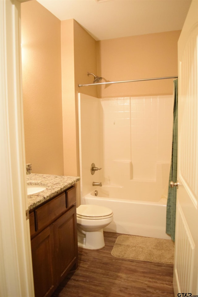 full bathroom with toilet, shower / tub combo with curtain, vanity, and hardwood / wood-style floors