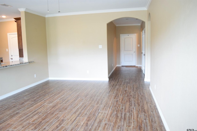 spare room featuring hardwood / wood-style flooring and crown molding