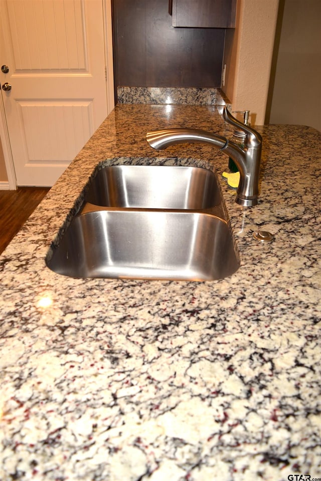 interior details featuring sink and stone countertops