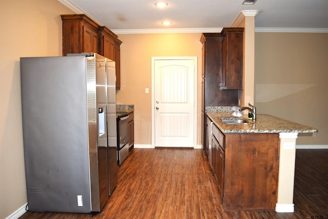 kitchen featuring stainless steel appliances, sink, light stone counters, ornamental molding, and dark wood-type flooring