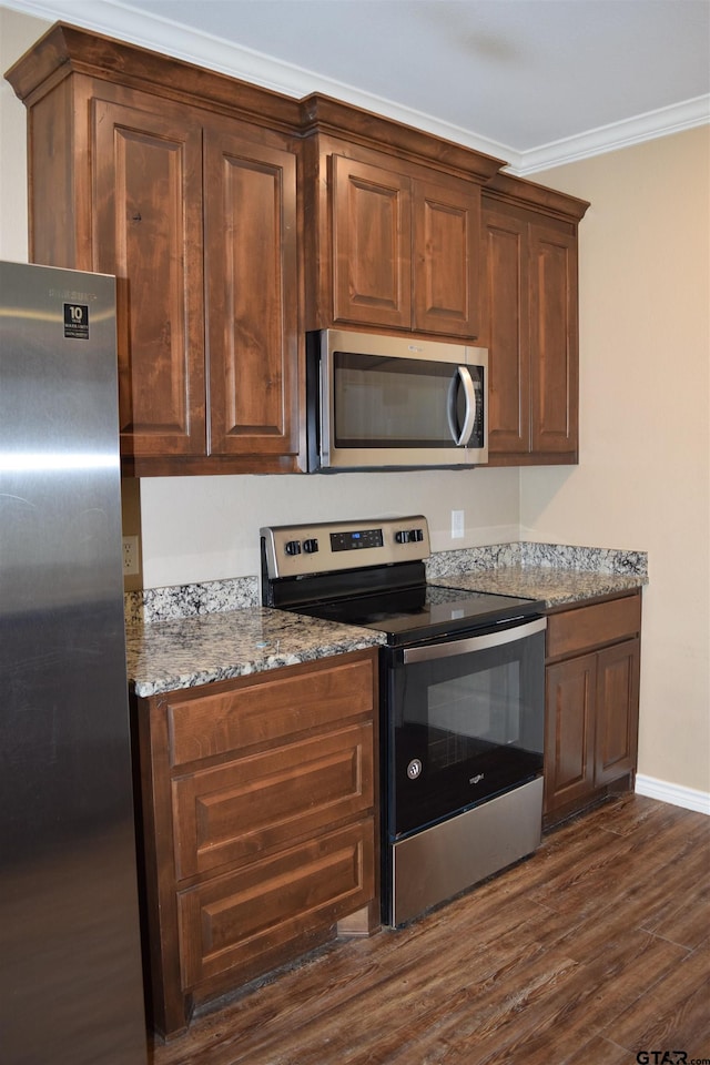 kitchen featuring stainless steel appliances, dark hardwood / wood-style floors, crown molding, and stone countertops