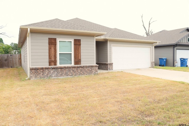 view of front of property with a garage and a front lawn