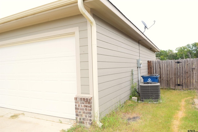 view of home's exterior featuring a garage and cooling unit