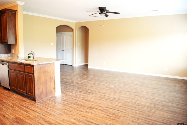 kitchen featuring light hardwood / wood-style floors, sink, stainless steel dishwasher, crown molding, and light stone countertops