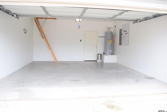 garage featuring electric water heater and electric panel