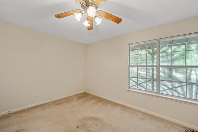 207 Pagosa Ln, Holly Lake Ranch, TX 75765 - unfurnished room with light carpet, baseboards, and ceiling fan
