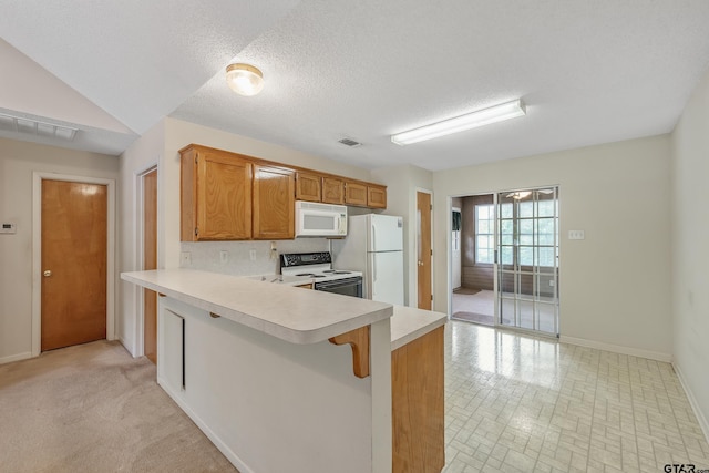 207 Pagosa Ln, Holly Lake Ranch, TX 75765 - kitchen with white appliances, light countertops, baseboards, a peninsula, and brown cabinets