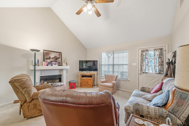 living room featuring high vaulted ceiling, light carpet, a fireplace, a ceiling fan, and baseboards