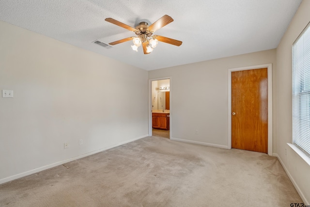 207 Pagosa Ln, Holly Lake Ranch, TX 75765 - unfurnished bedroom with light colored carpet, multiple windows, baseboards, and ensuite bath